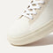 The toe and vamp of The High Top Sneaker in Sand Dune, in diagonal view.