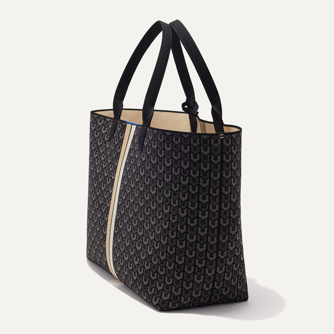 The Reversible Lightweight Mega Tote in Signature Black, shown from the side.