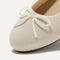 Close up of the rounded toe and bow detail of The Ballet Flat in Gardenia.