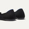 Close up of the heel of The Ballet Flat in Black, with Rothy's signature blue halo. 