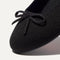 Close up of the rounded toe and bow detail of The Ballet Flat in Black. 