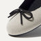 Close up of the rounded toe and bow detail of The Ballet Flat in Diamond Metallic. 