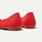 Close up of the heel of The Ballet Flat in Glamour Red, with Rothy's signature blue halo. 