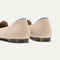 Close up of the heel of The Lounge Loafer in Cream, with Rothy's signature blue halo. 
