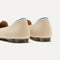 Close up of the heel of The Lounge Loafer in Sandstone, with Rothy's signature blue halo.