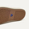 Outsole of The Ravello Slip On Sneaker in Black shown from below, in diagonal view. 