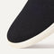 The toe and vamp of The Ravello Slip On Sneaker in Black, in diagonal view.