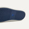 Outsole of The Ravello Slip On Sneaker in Dark Navy shown from below, in diagonal view. 