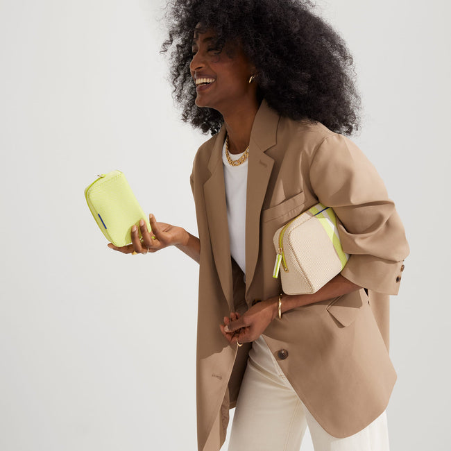 Model shown holding the large and small pouch of The Universal Pouch Set in Spring Colorblock.