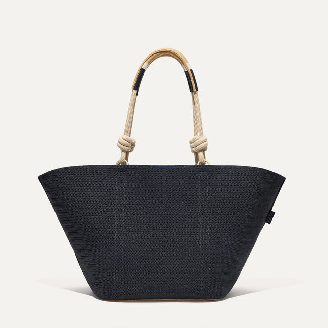 The Reversible Summer Tote in Black with reversible side visible.