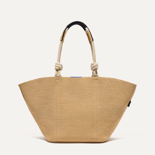 The Reversible Summer Tote in Camel with reversible side visible.