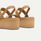 Close up of the heel of The Lightweight Wedge Sandal in Beach Sand Woven, with Rothy's signature blue halo.