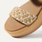 Close up of the toe strap of The Lightweight Wedge Sandal in Beach Sand Woven, in diagonal view.