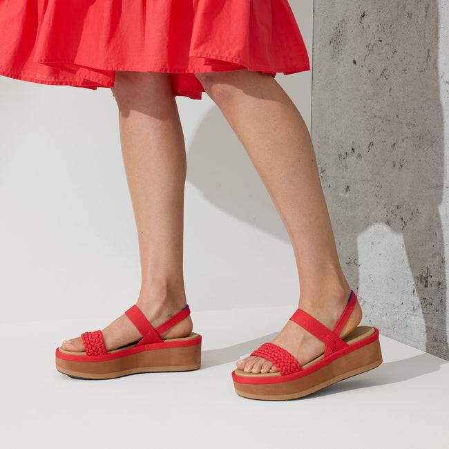 Model wearing The Lightweight Wedge Sandal in Red Hot Woven.