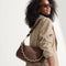 The Shoulder Strap in Chocolate Chain, shown paired with The Daily Crossbody, worn by a model and shown from the side. 
