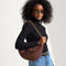 hover | The Shoulder Strap in Chocolate Chain, shown paired with The Crescent Bag, worn by a model and shown from the side. 