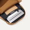 A close up of The Backpack in Hazelnut showing the interior pockets with a laptop, tablets and a phone inside.