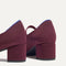 Close up of the heel of The Mary Jane Heel in Wine Red, with Rothy's signature blue halo.