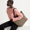 Alternate view of a model holding The Lightweight Zip Tote in Cacao Herringbone. 