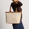 hover | Model holding The Lightweight Zip Tote in Vanilla Wafer.