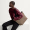 hover | A model carrying The Lightweight Zip Tote in Cacao Herringbone.