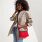 The Casual Crossbody in Red Crisp Basketweave, worn as a crossbody by a model, shown from the side.