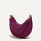The Mini Crescent Bag in Beet, shown from the side. 