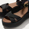 Close up of the straps of The Criss-Cross Lightweight Wedge Sandal in Black, in diagonal view. 