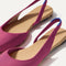 Close up of the strap on The Almond Slingback in Hibiscus, with Rothy's signature blue halo.