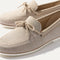 Close up of the vamp and knotted detail on The Boat Shoe in Shimmery Sand.