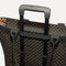 The Zip Travel Tote shown attached to a rolling suitcase using the wrap-around band.