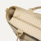 A close up of The Zip Travel Tote in  Parchment Basketweave, focusing on the zip closure and handles.