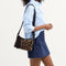 hover | The ReVelvet Casual Crossbody in ReVelvet Cat, carried by its crossbody strap by a model.