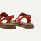 Close up of the heel of The T-Strap Sandal in Brick, with Rothy's signature blue halo. 