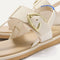 Close up of the T-strap and buckle detail of The T-Strap Sandal in Cream Puff. 