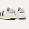 Close up of the heel of The Men's Court Sneaker in Black Drift, with Rothy's signature blue halo. 
