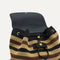 A close up of The Cinch Backpack in Mocha Stripe Crochet showing the drawstring closure.