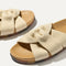 Close up of the twisting straps across the top of The Twist Slide in Coconut. 