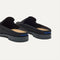 Close up of the heel of The Penny Loafer Mule in Black, with Rothy's signature blue halo.