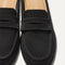 Close up of the toe and vamp of The Penny Loafer Mule in Black, showing the penny keeper detail.