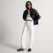 Alternate view of a model wearing The Penny Loafer Mule in Black.