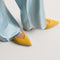 hover | Model wearing The Point III in ReVelvet Saffron. 