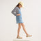 Alternate view of a model wearing The Kids Double Strap Sandal in Conch.