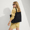 hover | Model holding The Lightweight Tote in Black Crochet.