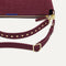 The Daily Crossbody in ReVelvet™ Syrah, lying flat, showing the detachable top handle and adjustable crossbody strap.