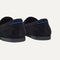 Close up of the heel of The Ravello Penny Loafer in ReVelvet™ Black, with Rothy's signature blue halo on the pull tab.