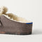 Close up of the heel of The Teddy Buckle Clog in Porcini, with Rothy's signature blue halo. 