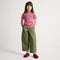Alternate view of a model wearing The Kids Clog in ReVelvet™ Fuchsia Burst. 