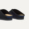 Close up of the heel of The Casual Clog in ReVelvet™ Black, with Rothy's signature blue halo. 