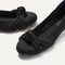 Close up of the rounded toe and knotted detail of The Knot Ballet Flat in Black.